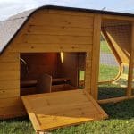 chicken coop with curved roof and circular door