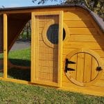 chicken coop with curved roof and circular door