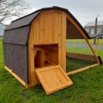 sloped chicken coop with closed door and roof
